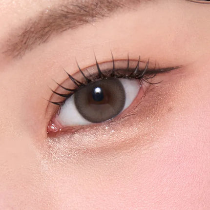 Model wearing OLENS Misty Ash Choco daily colored contacts for a soft blended innocent look