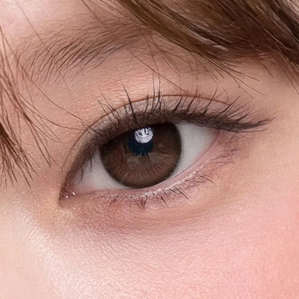 Model wearing OLENS Rain Mocha chocolate brown daily colored contacts for a soft and romantic look
