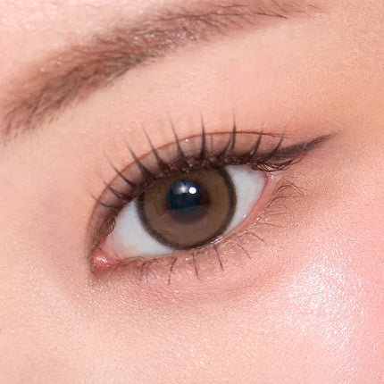 Model wearing OLENS Realish Brown monthly colored contacts for a natural deep 3D effect