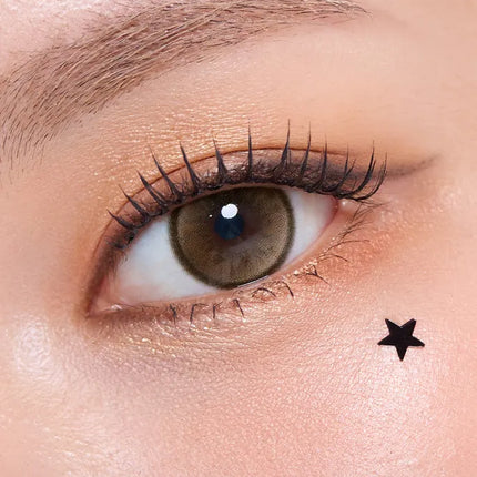 Model wearing OLENS Secret Tint Brown monthly colored contacts for soft and dewy caramel eyes